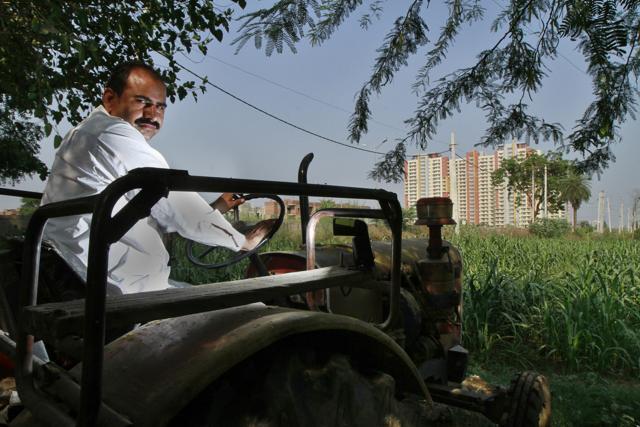 Manoj Yadav from Faridabad has continued to farm on his land, which has been acquired by the state. He has not taken compensation. (HT Photo/ Sanjeev Verma) Manoj Yadav from Faridabad has continued to farm on his land, which has been acquired by the state. He has not taken compensation. (HT Photo/ Sanjeev Verma)