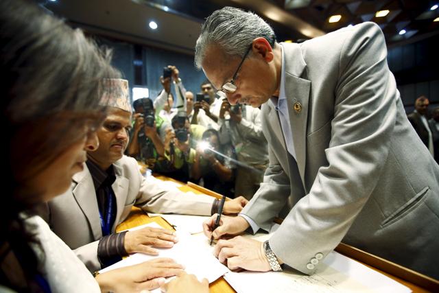 Baburam Bhattarai signs a copy of Nepal’s new Constitution at the parliament in Kathmandu, Nepal September 18, 2015. The Maoists ideologue resigned after expressing support for campaigning against the fledgling Constitution, which has been criticised from discriminating against the Tharu, Madhesi and Dalit communities as well as women. (REUTERS Photo) Baburam Bhattarai signs a copy of Nepal’s new Constitution at the parliament in Kathmandu, Nepal September 18, 2015. The Maoists ideologue resigned after expressing support for campaigning against the fledgling Constitution, which has been criticised from discriminating against the Tharu, Madhesi and Dalit communities as well as women. (REUTERS Photo)