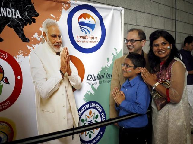A group of attendees gesture in front of a poster of Indian Prime Minister Narendra Modi before a community reception at SAP Center in San Jose, California. (REUTERS) A group of attendees gesture in front of a poster of Indian Prime Minister Narendra Modi before a community reception at SAP Center in San Jose, California. (REUTERS)