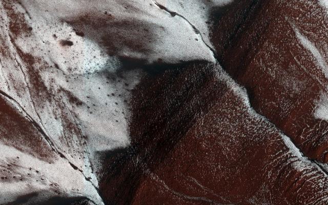 A file handout picture made available by NASA on 25 December 2014 shows an area on the surface of Mars, approximately 1.5 by three kilometers in size, displaying frosted gullies on a south-facing slope within a crater. (EPA) A file handout picture made available by NASA on 25 December 2014 shows an area on the surface of Mars, approximately 1.5 by three kilometers in size, displaying frosted gullies on a south-facing slope within a crater. (EPA)