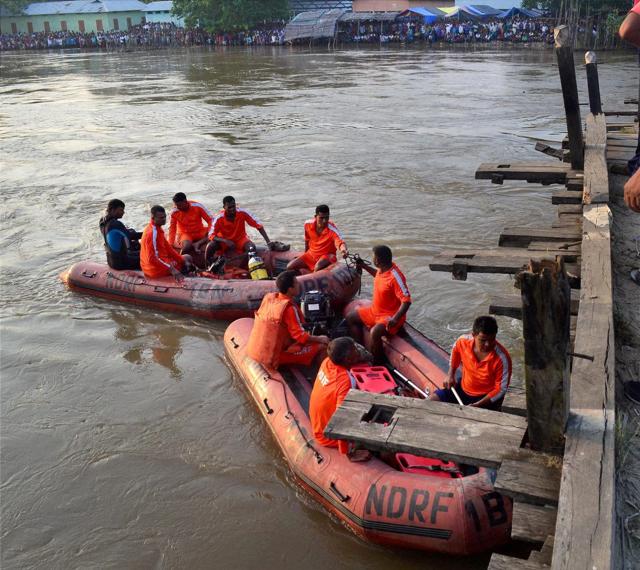 NDRF team searching for the bodies after a motor boat capsized in Kolohi river . (PTI)