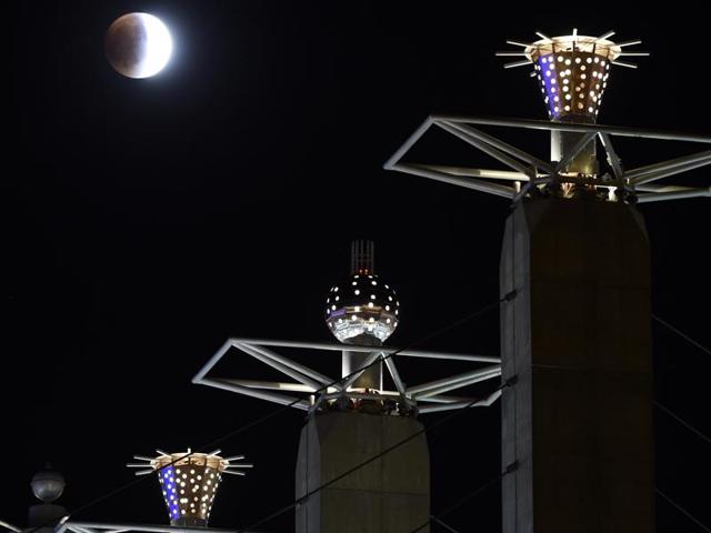 Earth's shadow begins to obscure a so-called supermoon during a lunar eclipse in Kansas City, Sunday, September 27, 2015. (AP Photo)