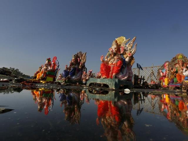 Tall, intact Ganesh idols were taken out of the Yamuna river after they were immersed, in New Delhi on Monday. (Ravi Choudhary/ Hindustan Times)