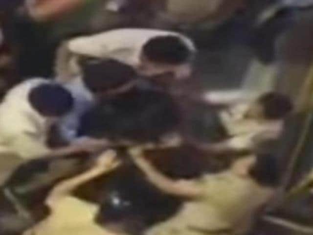 A video grab from IBN Live shows women constables beating up a woman. (YouTube/IBNLive) A video grab from IBN Live shows women constables beating up a woman. (YouTube/IBNLive)