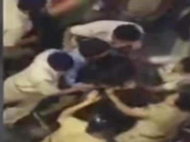 A video grab from IBN Live shows women constables beating up a woman. (YouTube/IBNLive) A video grab from IBN Live shows women constables beating up a woman. (YouTube/IBNLive)