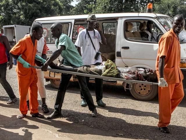 A wounded man is carried into the General Hospital in Bangui after unknown assailants opened fire in the PK5 district, a neighbourhood with a majority of Muslim residents. (AFP) A wounded man is carried into the General Hospital in Bangui after unknown assailants opened fire in the PK5 district, a neighbourhood with a majority of Muslim residents. (AFP)