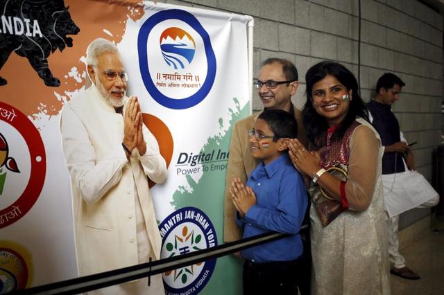 A group of attendees gesture in front of a poster of I Prime Minister Narendra Modi before a community reception at SAP Center in San Jose, California. (REUTERS) A group of attendees gesture in front of a poster of I Prime Minister Narendra Modi before a community reception at SAP Center in San Jose, California. (REUTERS)