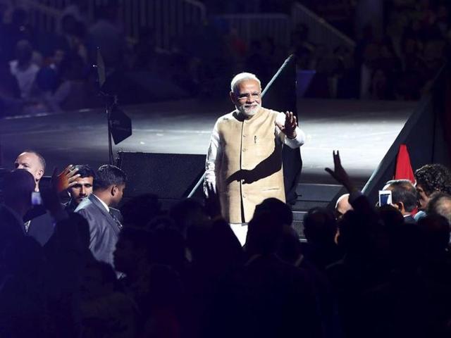 People wave the tricolour outside SAP Center before a community reception with Prime Minister Narendra Modi in San Jose, California.(REUTERS)