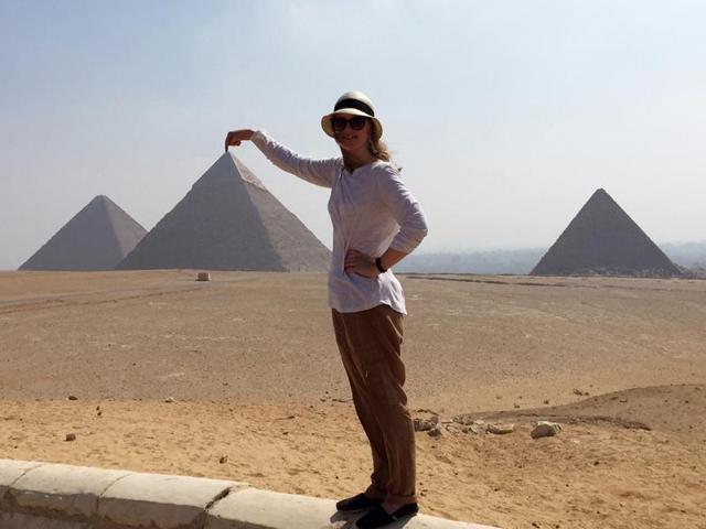 A foreigner poses with the pyramids in Giza. The pyramids continue to be the biggest draw for tourists coming into Egypt. (AP)
