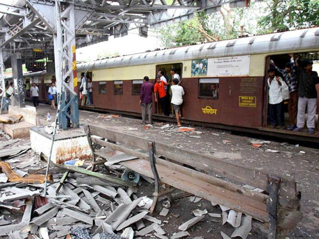 In this file photograph taken on July 12, 2006, commuters walk past the blast site at Mahim railway station in Mumbai, the day after a wave of coordinated blasts on commuter trains in Mumbai. (AFP File Photo) In this file photograph taken on July 12, 2006, commuters walk past the blast site at Mahim railway station in Mumbai, the day after a wave of coordinated blasts on commuter trains in Mumbai. (AFP File Photo)