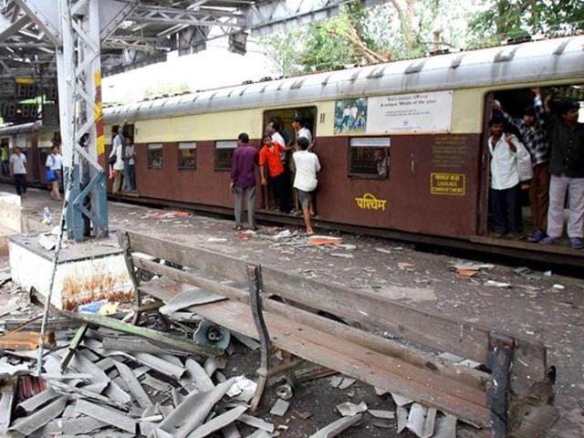 In this file photograph taken on July 12, 2006, commuters walk past the blast site at Mahim railway station in Mumbai, the day after a wave of coordinated blasts on commuter trains in Mumbai. (AFP File Photo) In this file photograph taken on July 12, 2006, commuters walk past the blast site at Mahim railway station in Mumbai, the day after a wave of coordinated blasts on commuter trains in Mumbai. (AFP File Photo)