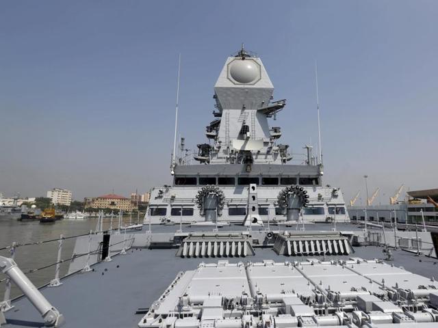 An Indian Navy personnel gestures on the deck of the newly built INS Kochi, a guided missile destroyer. The warship was commissioned on Wednesday by defence minister Manohar Parrikar at the naval dockyard in Mumbai. (Reuters Photo)