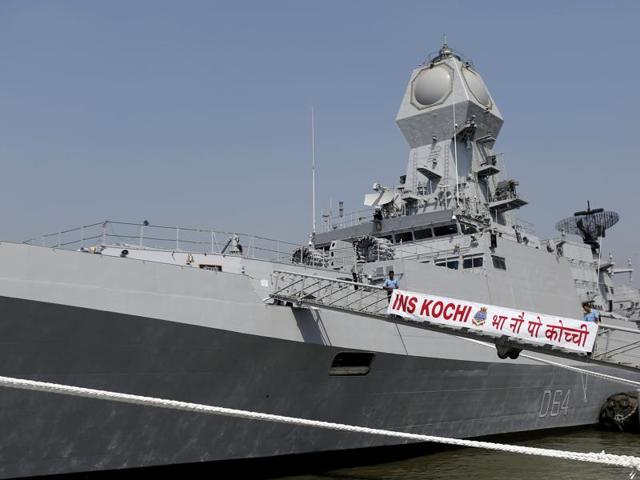 Indian Navy personnel board the newly built INS Kochi, a guided missile destroyer, during a media tour at the naval dockyard in Mumbai. (Reuters Photo)