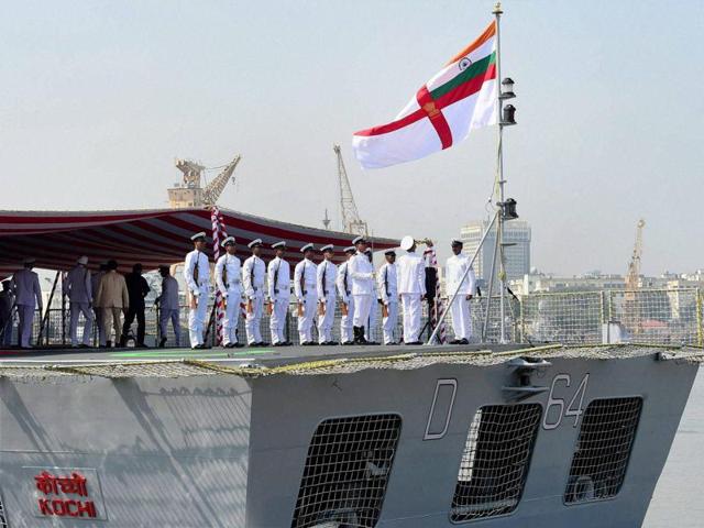 Naval officers hoisting the flag during the commissioning of naval warship INS Kochi in Mumbai. (PTI Photo)