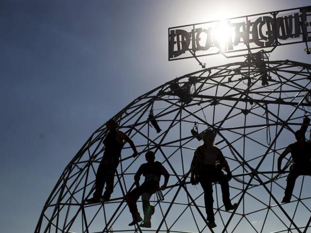 People climb on the Thunderdome as they watch a performance during the Wasteland Weekend event in California City, California September 26, 2015. The four-day event has a post-apocalyptic theme and is inspired by the Mad Max movie franchise. (REUTERS)