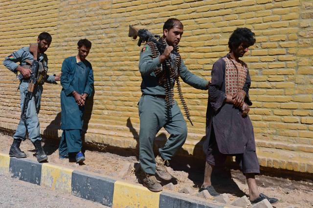 Afghan policemen walk with captured Taliban fighters as they are presented to the media in Herat. Forces launched an operation targeting a group of anti-government gunmen in Enjeel district, in which three Taliban fighters were killed and three wounded. (AFP Photo) Afghan policemen walk with captured Taliban fighters as they are presented to the media in Herat. Forces launched an operation targeting a group of anti-government gunmen in Enjeel district, in which three Taliban fighters were killed and three wounded. (AFP Photo)
