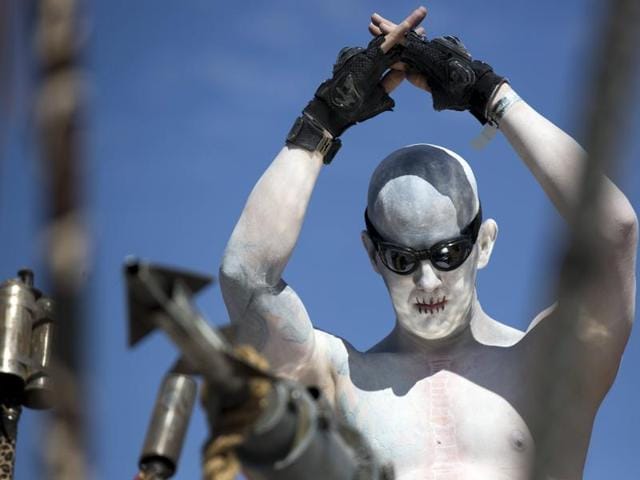 Witness an enthusiast as he salutes from a vehicle during Wasteland Weekend event in California City, California September 26, 2015. The four-day event has a post-apocalyptic theme and is inspired by the Mad Max movie franchise. (REUTERS)