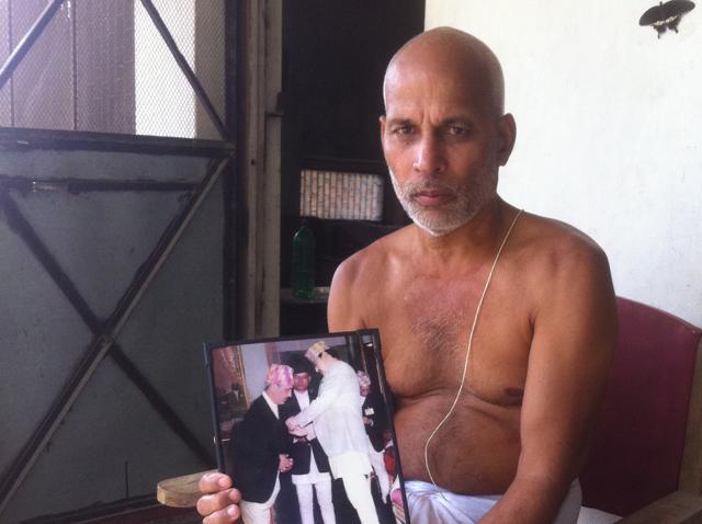 Binay Chaudhary lost both his father and his son due to police firing. Here, he shows a picture where his father is receiving honours from King Birendra. (Prashant Jha/HT Photo)