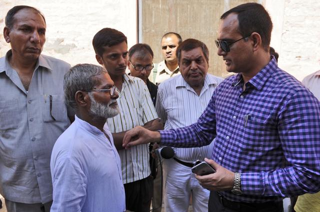 Additional District Magistrate (ADM) Rajesh Yadav speaks to Ikhlaq's brother. (Burhaan Kinu / HT Photo) Additional District Magistrate (ADM) Rajesh Yadav speaks to Ikhlaq's brother. (Burhaan Kinu / HT Photo)