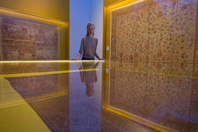 A member of museum staff poses for photographers looking at a Karuppur shawl during a press preview of "The Fabric of India" exhibition at the Victoria and Albert Museum in London. (AFP) A member of museum staff poses for photographers looking at a Karuppur shawl during a press preview of "The Fabric of India" exhibition at the Victoria and Albert Museum in London. (AFP)