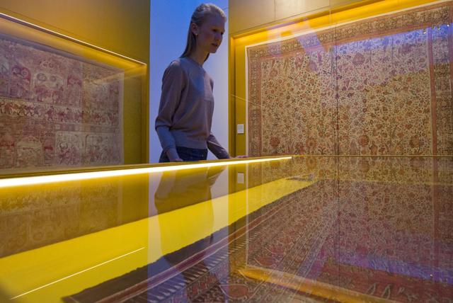 A member of museum staff poses for photographers looking at a Karuppur shawl during a press preview of "The Fabric of India" exhibition at the Victoria and Albert Museum in London. (AFP) A member of museum staff poses for photographers looking at a Karuppur shawl during a press preview of "The Fabric of India" exhibition at the Victoria and Albert Museum in London. (AFP)