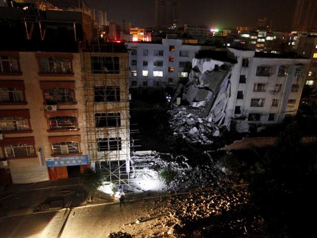 Chinese police officers stand at the scene of an explosion in Liucheng county in southern China. (AP) Chinese police officers stand at the scene of an explosion in Liucheng county in southern China. (AP)
