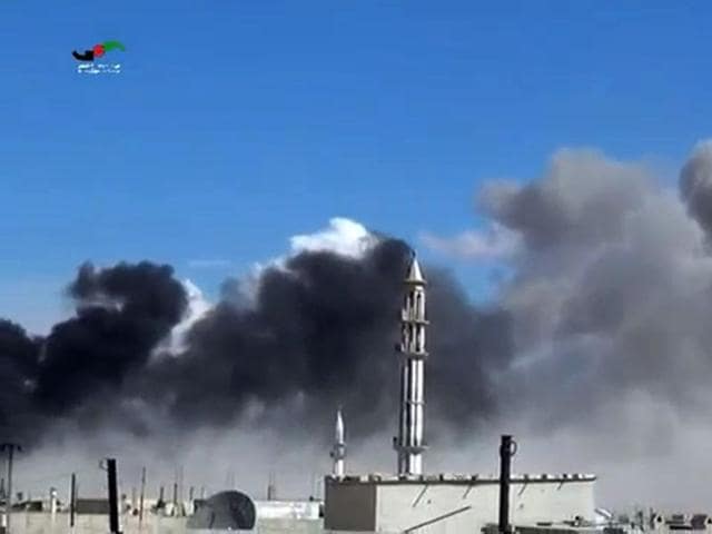 An image grab taken from a video released by the Homs Media Center on September 30, 2015 shows smoke billowing from buildings and a minaret in the central Syrian town of Talbisseh in Homs province. (AFP) An image grab taken from a video released by the Homs Media Center on September 30, 2015 shows smoke billowing from buildings and a minaret in the central Syrian town of Talbisseh in Homs province. (AFP)