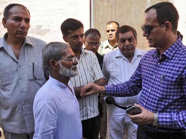 Additional district magistrate Rajesh Yadav with Ikhlaq's brother. (Burhaan Kinu/HT Photo) Additional district magistrate Rajesh Yadav with Ikhlaq's brother. (Burhaan Kinu/HT Photo)