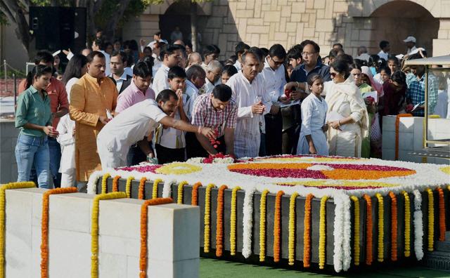 People paying tribute to Mahatma Gandhi at Rajghat, to mark the occasion of his birth. (PTI Photo) People paying tribute to Mahatma Gandhi at Rajghat, to mark the occasion of his birth. (PTI Photo)