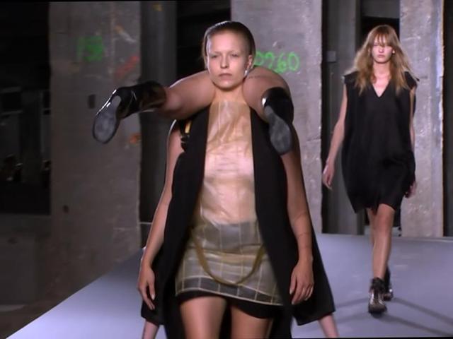 In this image taken from video, a model carries another model on the runway as part of American designer Rick Owens' Spring-Summer 2016 ready-to-wear fashion collection, presented during the Paris Fashion Week. (AP) In this image taken from video, a model carries another model on the runway as part of American designer Rick Owens' Spring-Summer 2016 ready-to-wear fashion collection, presented during the Paris Fashion Week. (AP)