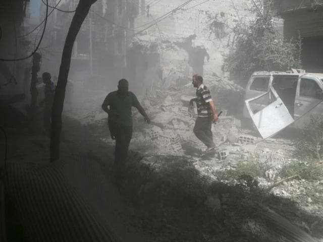 Residents inspect damage from what activists said was an airstrike by forces loyal to Syria's President Bashar al-Assad on the town of Douma, eastern Ghouta in Damascus. (REUTERS) Residents inspect damage from what activists said was an airstrike by forces loyal to Syria's President Bashar al-Assad on the town of Douma, eastern Ghouta in Damascus. (REUTERS)