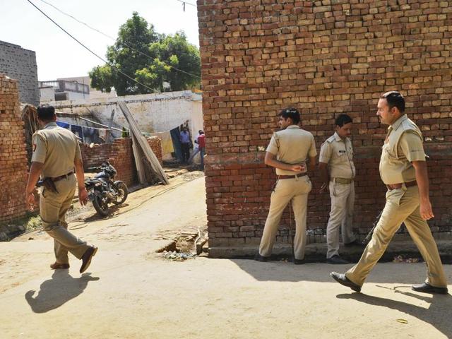Policemen patrol outside the house of Mohmmad Ikhlaq who was killed by a mob over an allegation of cow slaughtering at Bisada village in Greater Noida.(Burhaan Kinu / HT Photo)