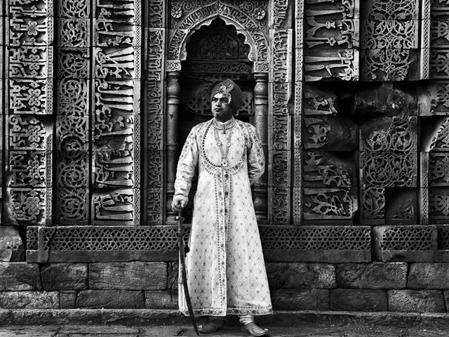 Subodh Gupta, artist, son of the soil and dabba-wala in disguise. Picture made against the calligraphic wall of the Qutab Minar. (JJ Valaya) 