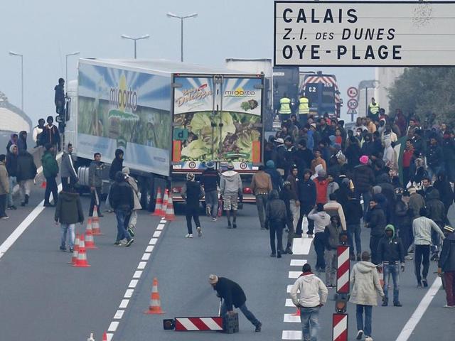 Dozens of migrants gather near lorries which head towards the ferry terminal in Calais, France. (REUTERS) Dozens of migrants gather near lorries which head towards the ferry terminal in Calais, France. (REUTERS)