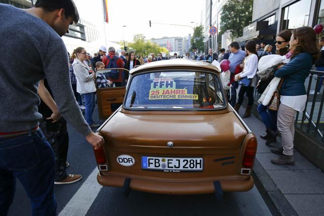 People look at a GDR-made Trabant car during the celebrations of the 25th anniversary since the reunification of East and West Germany, in Frankfurt. (REUTERS)