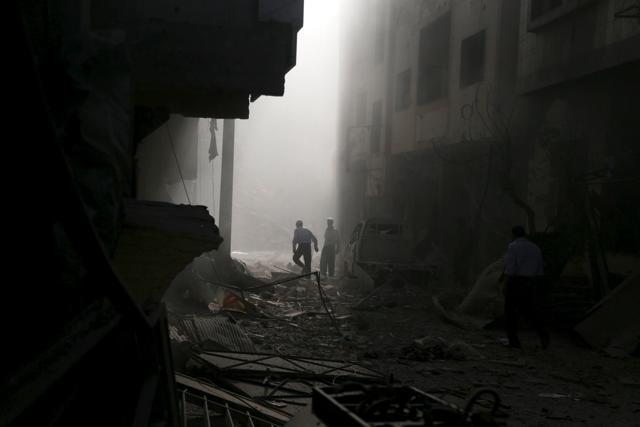 Residents inspect damage from what activists said was an airstrike by forces loyal to Syria’s President Bashar al-Assad on the town of Douma, in Damascus. (Reuters Photo) Residents inspect damage from what activists said was an airstrike by forces loyal to Syria’s President Bashar al-Assad on the town of Douma, in Damascus. (Reuters Photo)