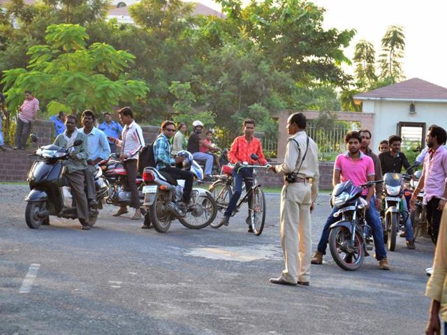 Forest guards try to stop people from going towards Kaliasot Dam on Friday afternoon as the Tiger T-1 was spotted in the area a few days back.(Mujeeb Faruqui/HT photo)