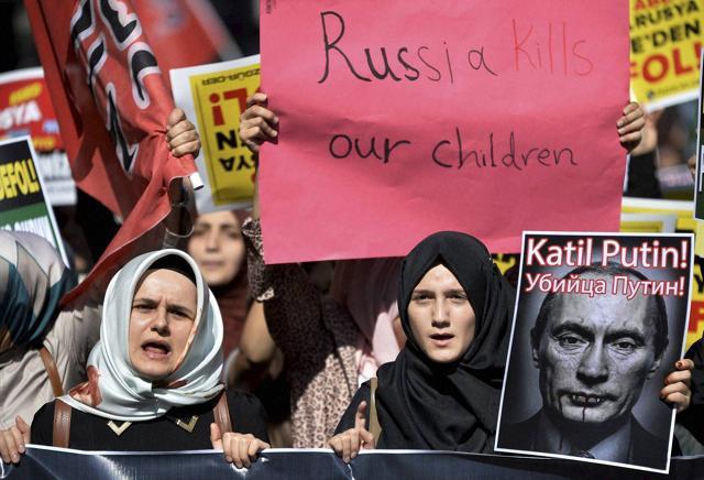 Istanbul : Demonstrators hold placards and a picture depicting Russian President Vladimir Putin during a protest against Russian military operations in Syria. (AP/PTI Photo) Istanbul : Demonstrators hold placards and a picture depicting Russian President Vladimir Putin during a protest against Russian military operations in Syria. (AP/PTI Photo)