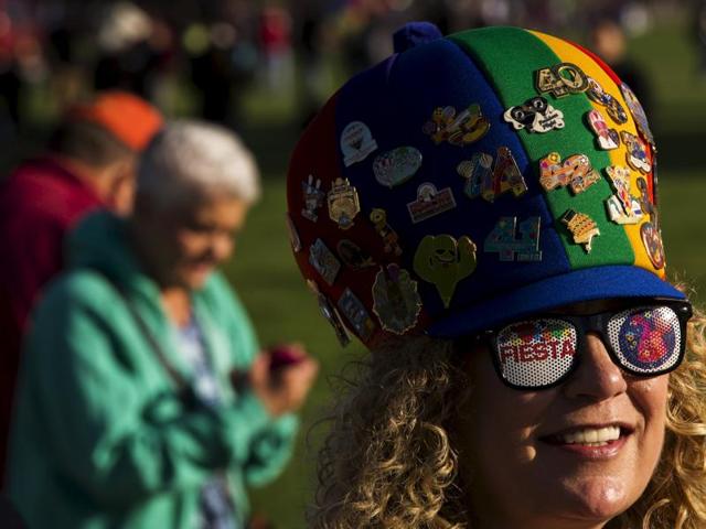 An attendee smiles as she watches hundreds of hot air balloons lift off. (REUTERS)