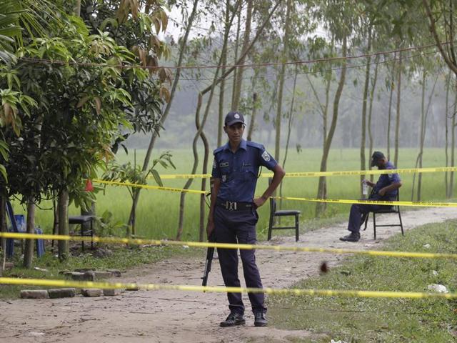 Bangladeshi security officers stand by the site where a Japanese Kunio Hoshi was killed at Mahiganj village in Rangpur district, Bangladesh, Sunday, Oct. 4, 2015. (AP) Bangladeshi security officers stand by the site where a Japanese Kunio Hoshi was killed at Mahiganj village in Rangpur district, Bangladesh, Sunday, Oct. 4, 2015. (AP)
