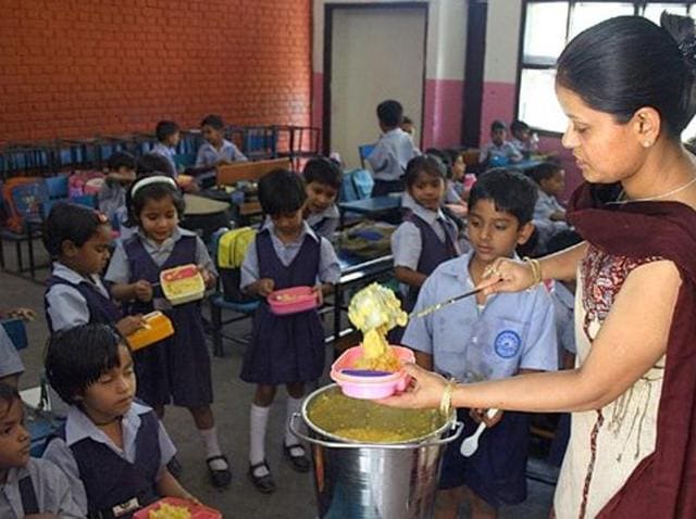 Children being served the mid-day meal. (HT Photo) Children being served the mid-day meal. (HT Photo)