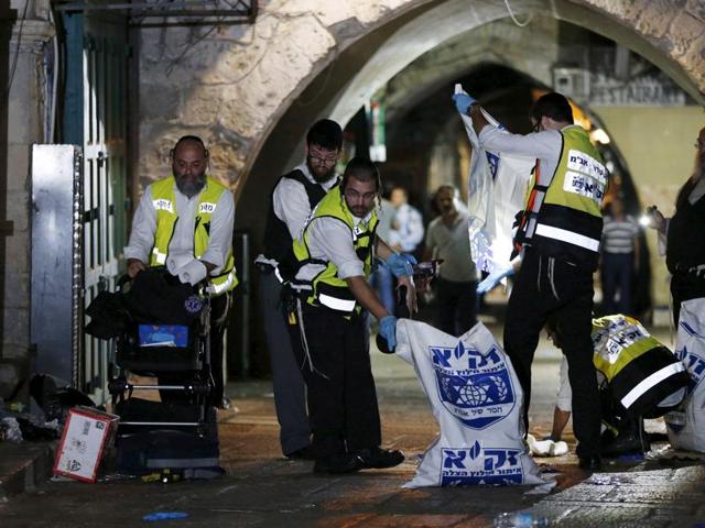 Members of the Zaka Rescue and Recovery team clean the scene where a Palestinian was shot dead after he stabbed and killed two people in Jerusalem's Old City October 3, 2015. (REUTERS) Members of the Zaka Rescue and Recovery team clean the scene where a Palestinian was shot dead after he stabbed and killed two people in Jerusalem's Old City October 3, 2015. (REUTERS)