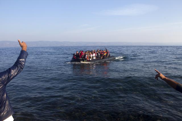 Refugees and migrants arrive on an overcrowded dinghy on the Greek island of Lesbos, after crossing a part of the Aegean Sea from the Turkish coast. (REUTERS)