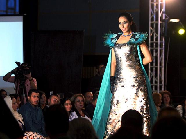 Silver shine and aqua-marine blue: A model presents a creation in Basra on October 4, 2015. (Reuters)