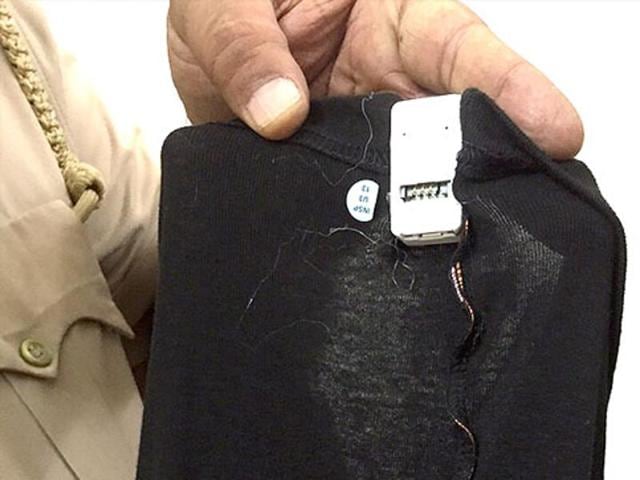 Gadgets stitched within undergarments meant to provide answer keys to candidates at the examination centre being displayed by a policeman.(Manoj Dhaka/ HT file photo)