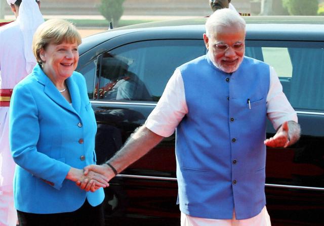 Prime Minister Narendra Modi welcomes German Chancellor Angela Merkel as she arrived for the ceremonial reception at the forecourt of Rashtrapati Bhawan in New Delhi. (PTI) Prime Minister Narendra Modi welcomes German Chancellor Angela Merkel as she arrived for the ceremonial reception at the forecourt of Rashtrapati Bhawan in New Delhi. (PTI)
