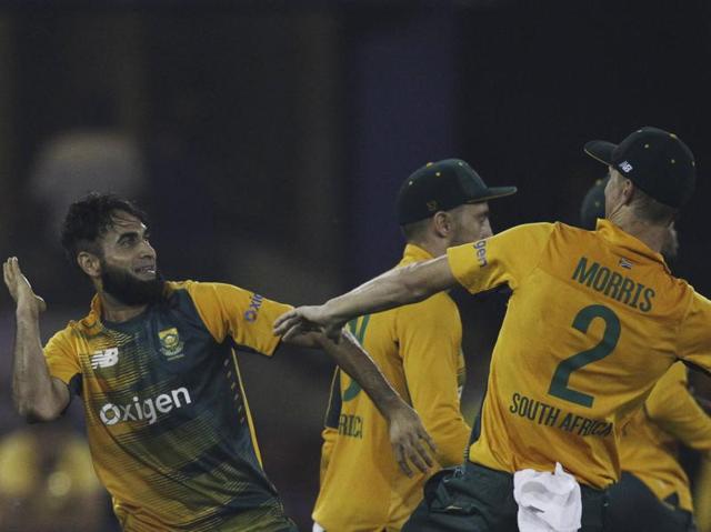 South Africa's Imran Tahir, left celebrates the wicket of India's Suresh Raina with teammate Chris Morris. (AP Photo)