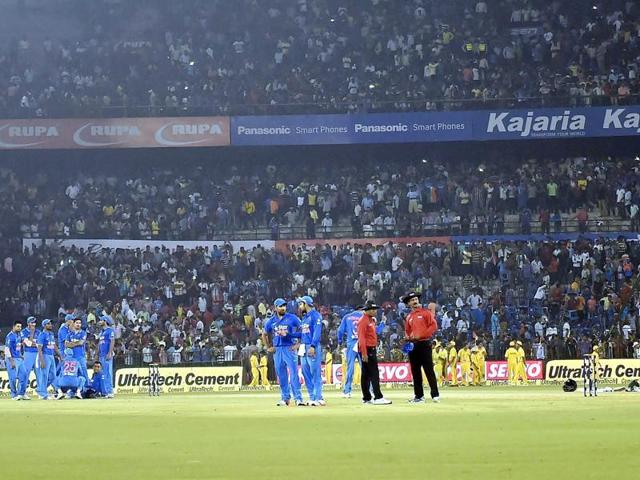 Indian and South African players, as well as match officials, wait for play to resume. (PTI Photo)
