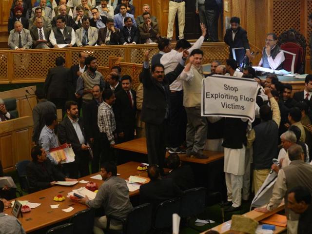 Banners were raised asking government `to stop exploiting the flood victims’ during Jammu and Kashmir assembly session on Monday. (Waseem Andrabi/HT )