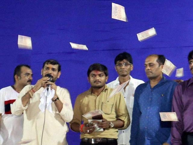 Members of Patidar Yuva Sangathan shower money on convener of Patidar Anamat Andolan Samiti, Hardik Patel at an event of Lok Dayro in Surat on Sunday. (PTI) Members of Patidar Yuva Sangathan shower money on convener of Patidar Anamat Andolan Samiti, Hardik Patel at an event of Lok Dayro in Surat on Sunday. (PTI)